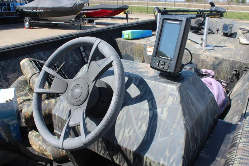 Slide: The Image of 2014 Lowe Roughneck 1756 boat interior with steering wheel and fish finder. - 8