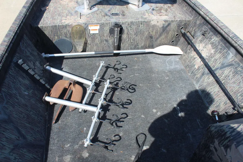 Slide: The Image of 2014 Lowe Roughneck 1756 boat interior with fishing rod holders and equipment. - 9