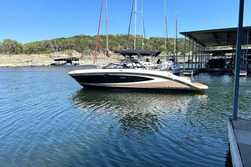 Slide: The Image of 2015 Sea Ray 270 Sundeck boat on water, sunny day. - 1