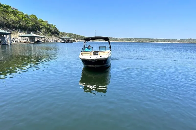 Slide: The Image of 2015 Sea Ray 270 Sundeck boat on calm lake with clear blue sky. - 10