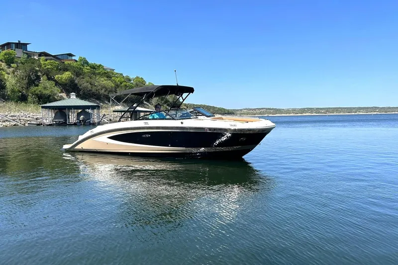 Slide: The Image of 2015 Sea Ray 270 Sundeck boat on calm lake with scenic background. - 14