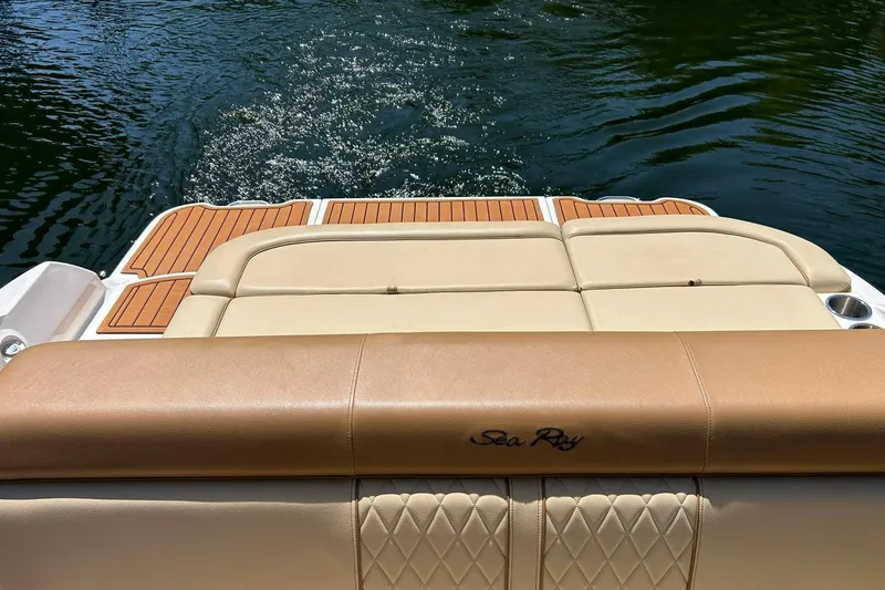Slide: The Image of 2015 Sea Ray 270 Sundeck boat with tan seating and teak deck on water. - 27