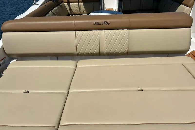 Slide: The Image of 2015 Sea Ray 270 Sundeck boat interior with beige and brown seating. - 28