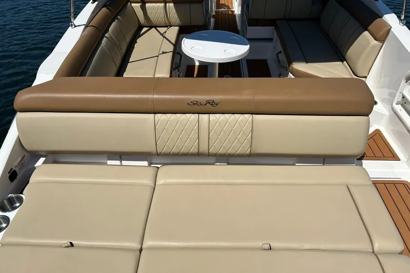 Slide: The Image of 2015 Sea Ray 270 Sundeck interior with beige and brown seating, table, and cup holders. - 29