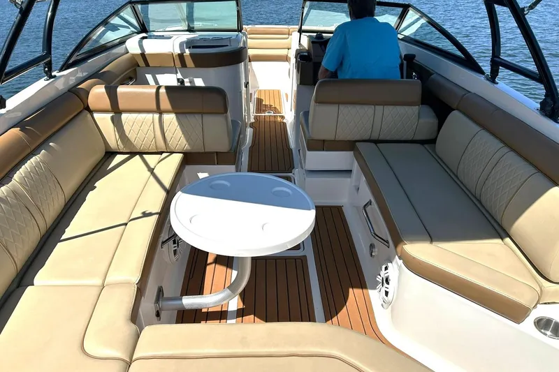 Slide: The Image of 2015 Sea Ray 270 Sundeck interior with spacious seating and table on a sunny day. - 30