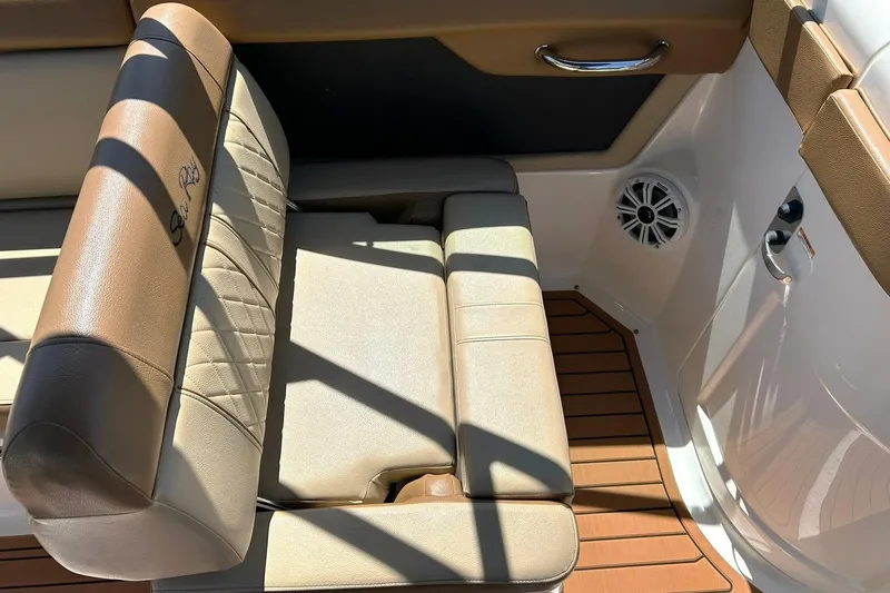 Slide: The Image of 2015 Sea Ray 270 Sundeck interior with tan seating and wood-style flooring. - 35