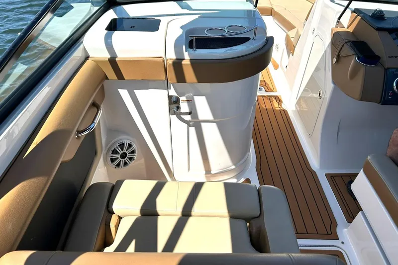 Slide: The Image of 2015 Sea Ray 270 Sundeck interior with tan seating and wood-style flooring. - 38