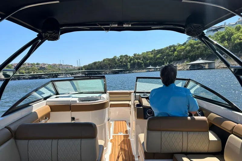 Slide: The Image of 2015 Sea Ray 270 Sundeck cruising on a sunny lake with scenic shoreline views. - 41