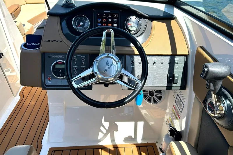 Slide: The Image of 2015 Sea Ray 270 Sundeck helm with steering wheel and control panel. - 47