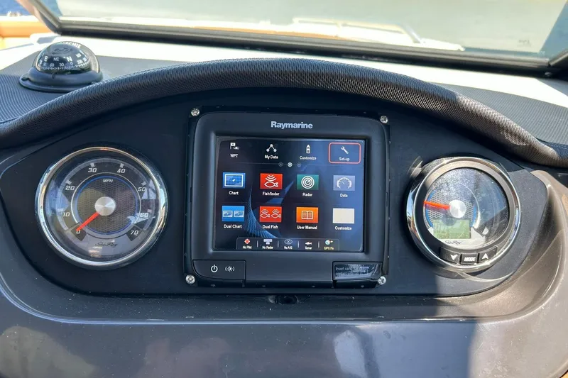 Slide: The Image of Dashboard of a 2015 Sea Ray 270 Sundeck with Raymarine display and gauges. - 49