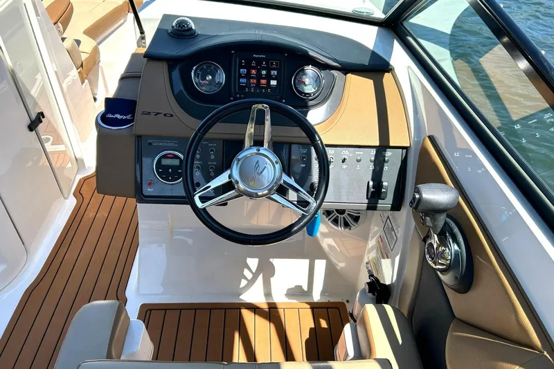 Slide: The Image of 2015 Sea Ray 270 Sundeck helm with steering wheel and control panel. - 5