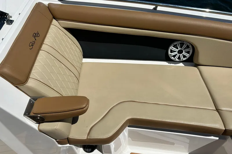 Slide: The Image of 2015 Sea Ray 270 Sundeck boat seating with tan upholstery and speaker. - 56