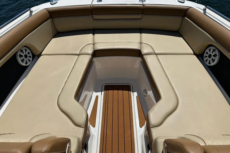 Slide: The Image of 2015 Sea Ray 270 Sundeck interior with tan seating and wood accents. - 58