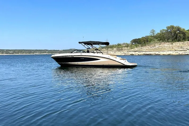 Slide: The Image of 2015 Sea Ray 270 Sundeck boat on a calm lake under clear blue sky. - 6