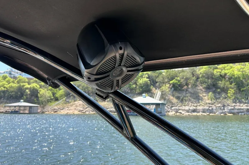 Slide: The Image of Speaker mounted on a 2015 Sea Ray 270 Sundeck boat, overlooking a scenic lake. - 61