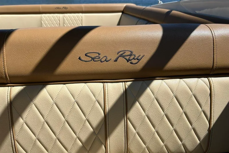Slide: The Image of Beige leather interior of 2015 Sea Ray 270 Sundeck boat with logo. - 66