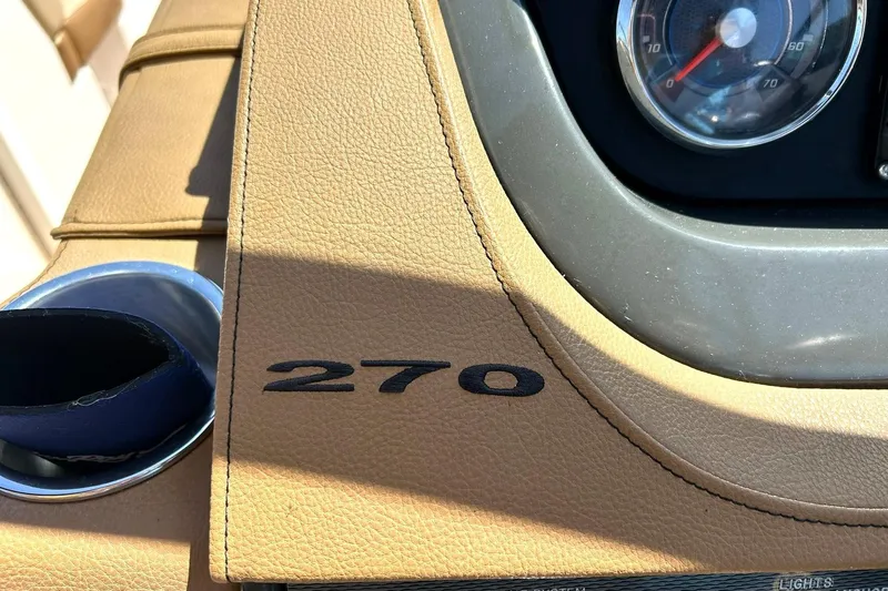 Slide: The Image of Dashboard of a 2015 Sea Ray 270 Sundeck boat with speedometer and cup holder. - 67