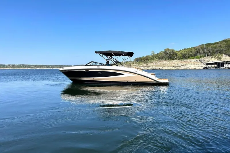 Slide: The Image of 2015 Sea Ray 270 Sundeck boat on calm lake with clear blue sky. - 8