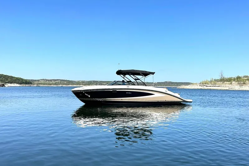 Slide: The Image of 2015 Sea Ray 270 Sundeck boat on calm lake under clear blue sky. - 9