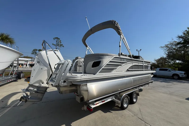 Slide: The Image of 2026 Bennington 22 LFB pontoon boat on trailer, featuring sleek design and modern outboard motor. - 10