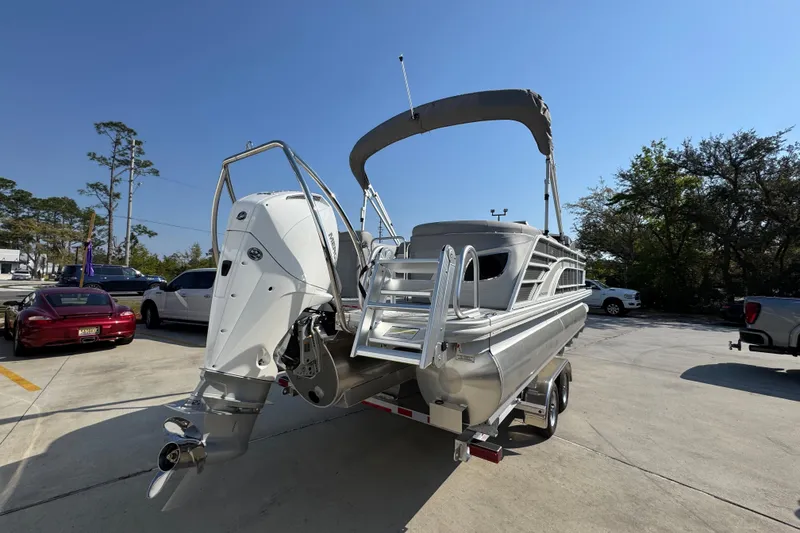 Slide: The Image of 2026 Bennington 22 LFB pontoon boat on trailer in sunny parking lot. - 11