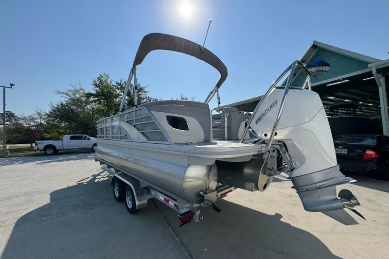 Slide: The Image of 2026 Bennington 22 LFB pontoon boat with Mercury outboard engine on trailer. - 14