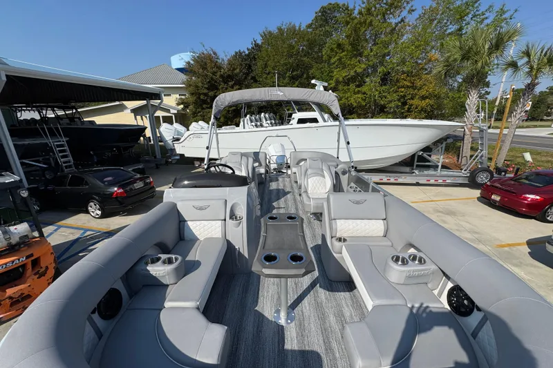 Slide: The Image of 2026 Bennington 22 LFB pontoon boat with luxurious seating and modern design in a marina. - 17