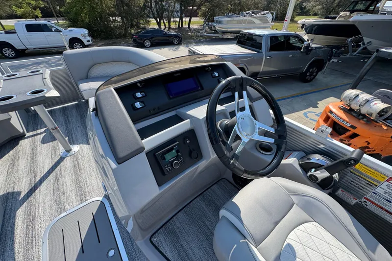 Slide: The Image of 2026 Bennington 22 LFB boat interior with steering wheel and control panel. - 24