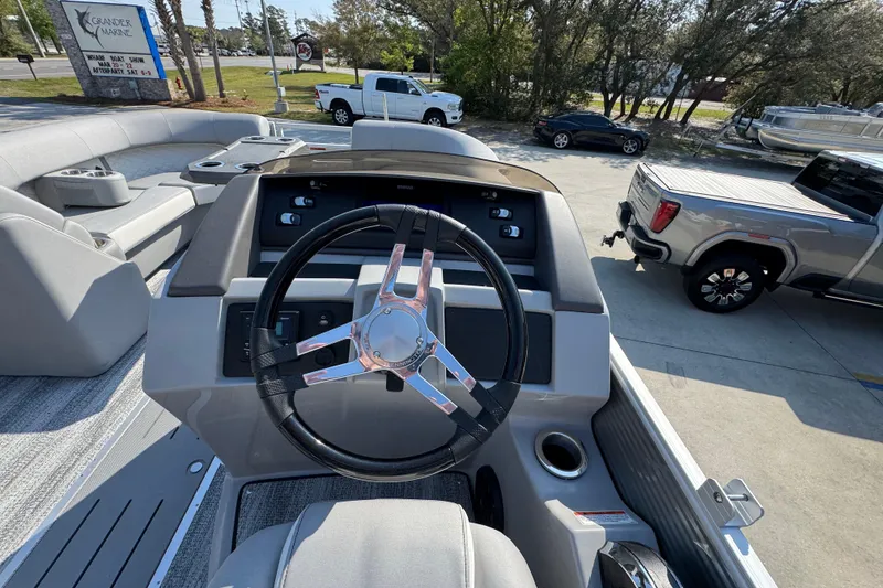 Slide: The Image of Steering console of 2026 Bennington 22 LFB pontoon boat, featuring modern controls and seating. - 25