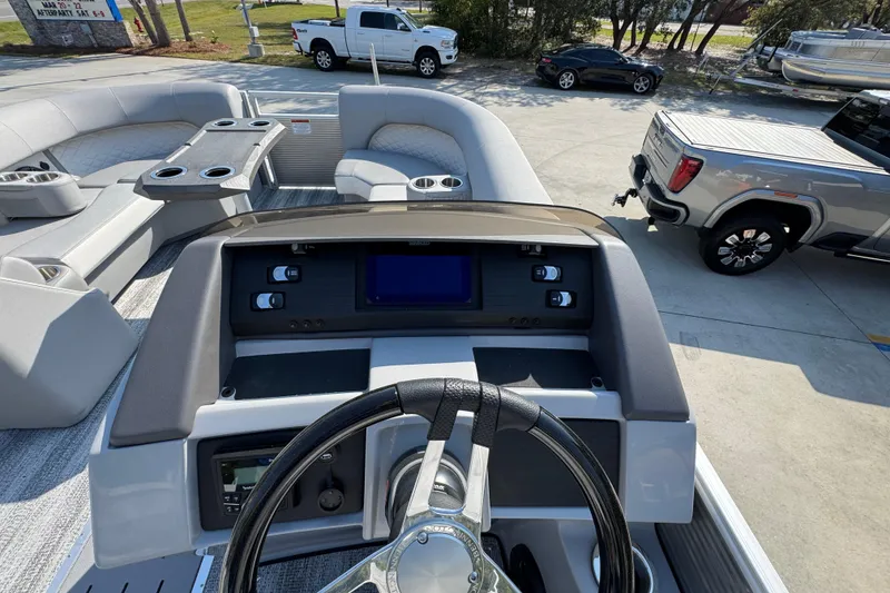 Slide: The Image of 2026 Bennington 22 LFB boat interior with steering wheel and seating area. - 26