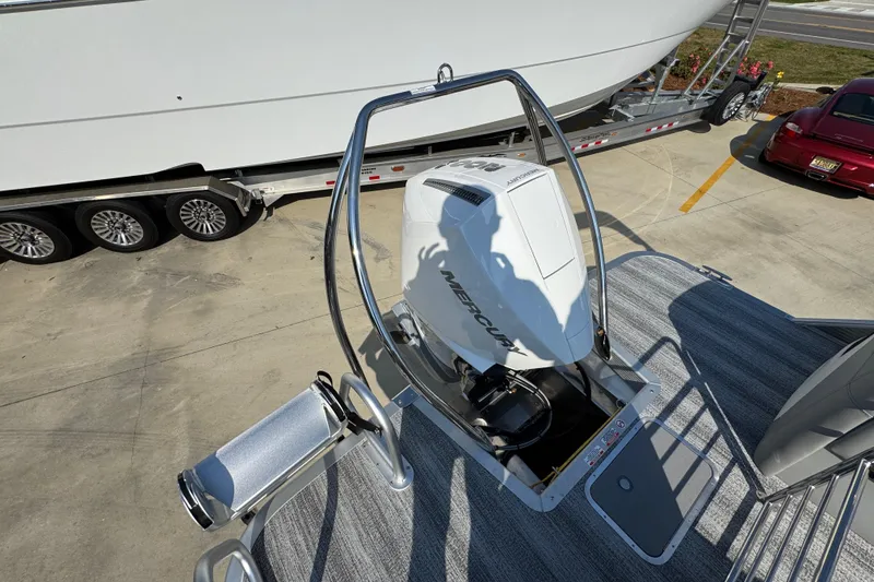 Slide: The Image of 2026 Bennington 22 LFB boat with Mercury outboard motor on a trailer. - 32