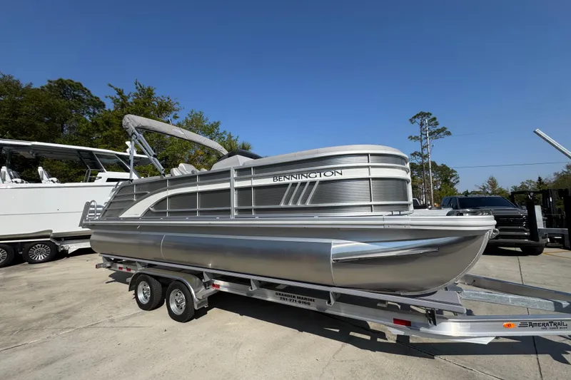 Slide: The Image of 2026 Bennington 22 LFB pontoon boat on trailer, parked outdoors. - 7