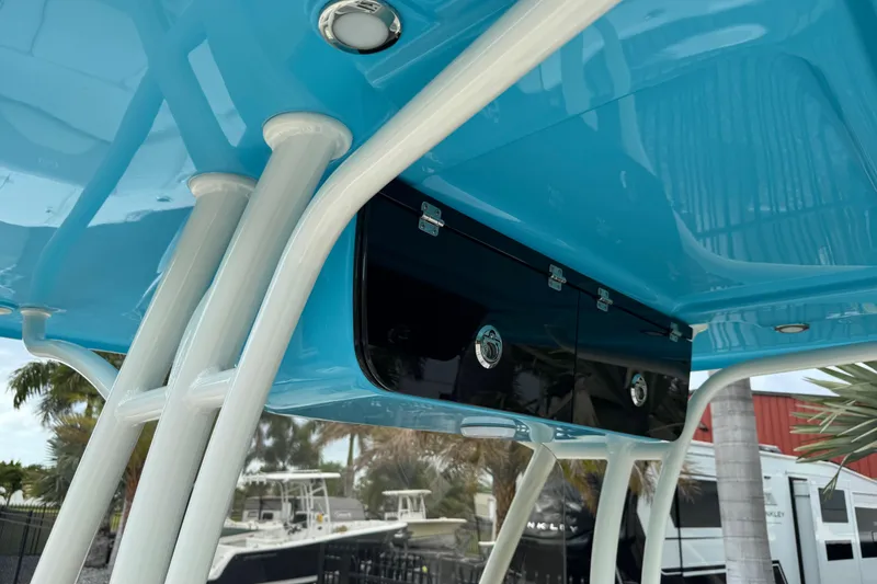Slide: The Image of 2024 Key West 263 FS boat with blue T-top and storage compartments. - 100