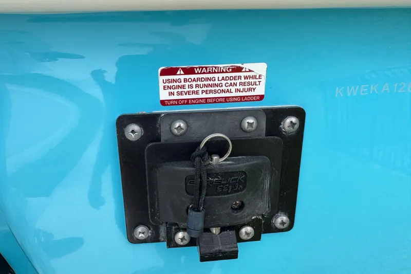Slide: The Image of 2024 Key West 263 FS boat warning label near boarding ladder. - 15