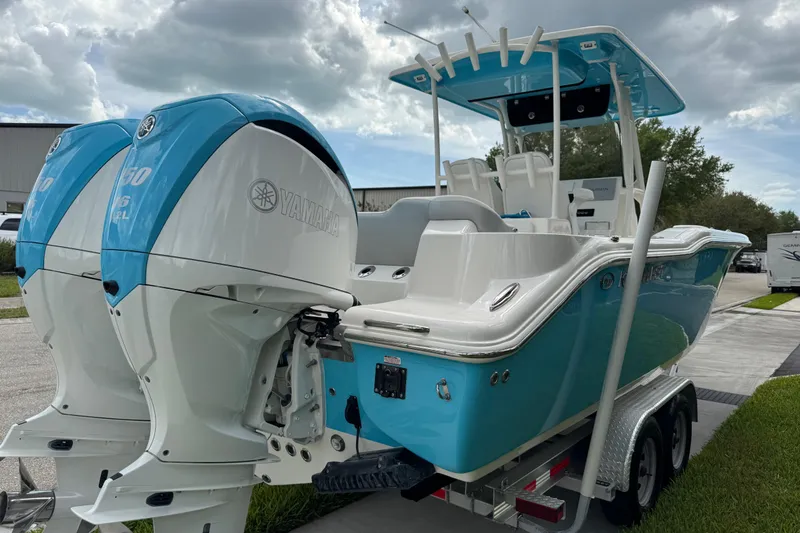 Slide: The Image of 2024 Key West 263 FS boat with twin Yamaha engines on a trailer. - 17