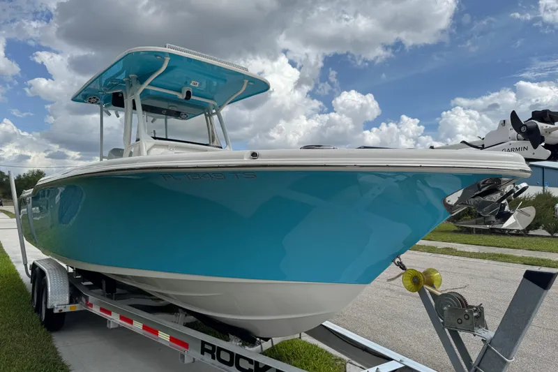 Slide: The Image of 2024 Key West 263 FS boat on trailer under cloudy sky. - 18
