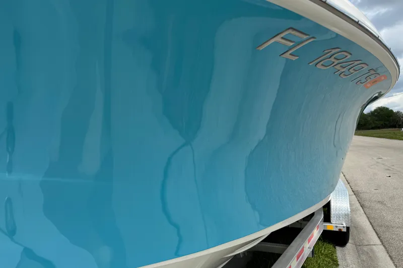 Slide: The Image of 2024 Key West 263 FS boat with blue hull and registration number. - 21