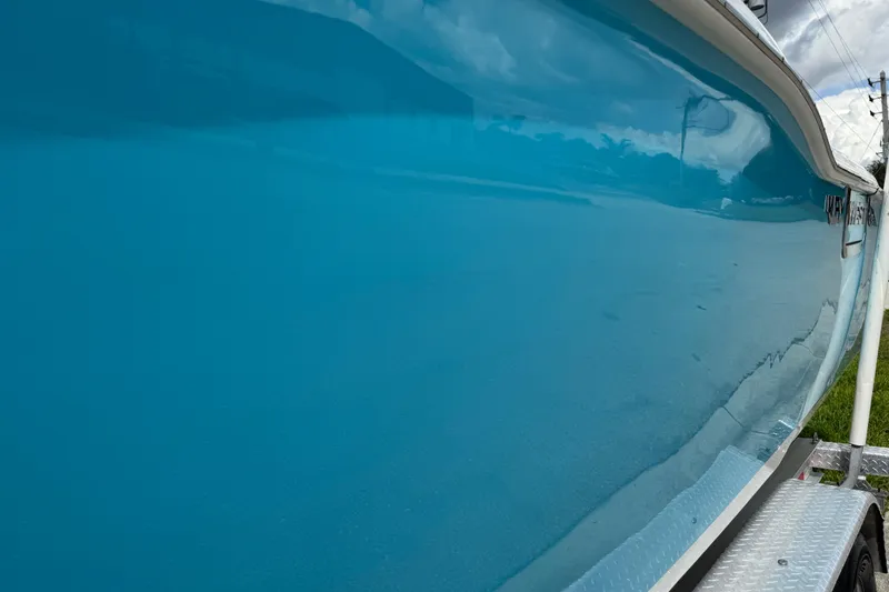 Slide: The Image of 2024 Key West 263 FS boat with sleek blue hull on a trailer. - 23