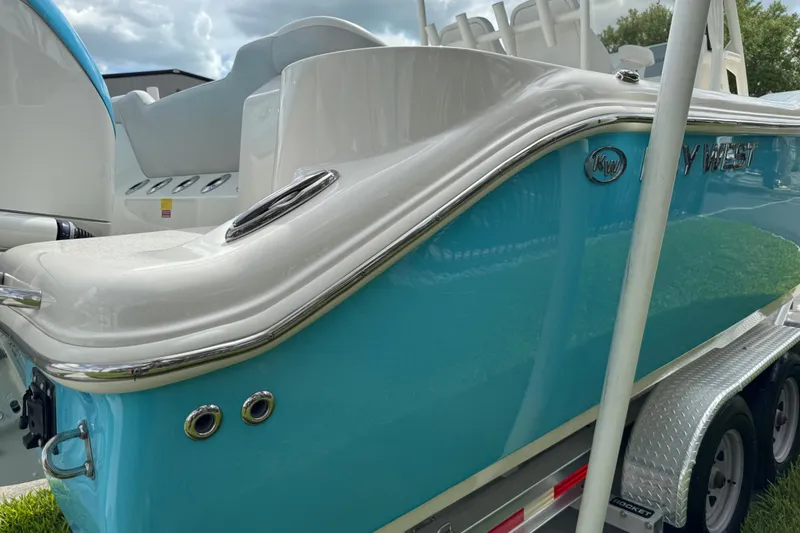 Slide: The Image of 2024 Key West 263 FS boat, blue and white exterior, on a trailer. - 25