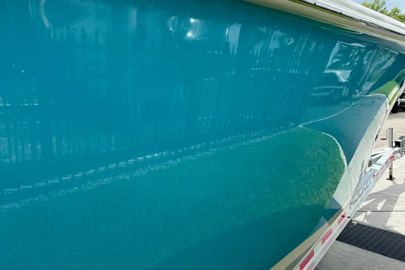 Slide: The Image of 2024 Key West 263 FS boat hull in vibrant blue on trailer. - 27