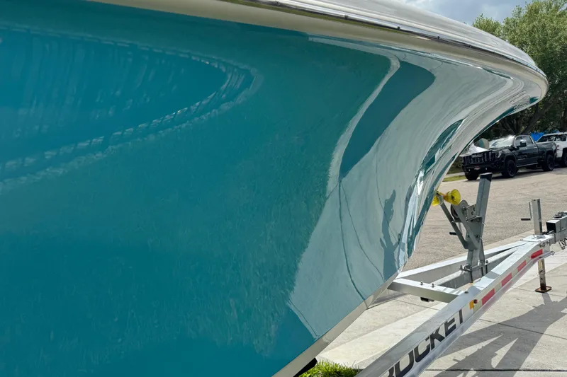 Slide: The Image of 2024 Key West 263 FS boat on trailer, showcasing sleek turquoise hull design. - 28