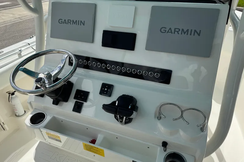 Slide: The Image of 2024 Key West 263 FS boat dashboard with Garmin displays and steering wheel. - 31