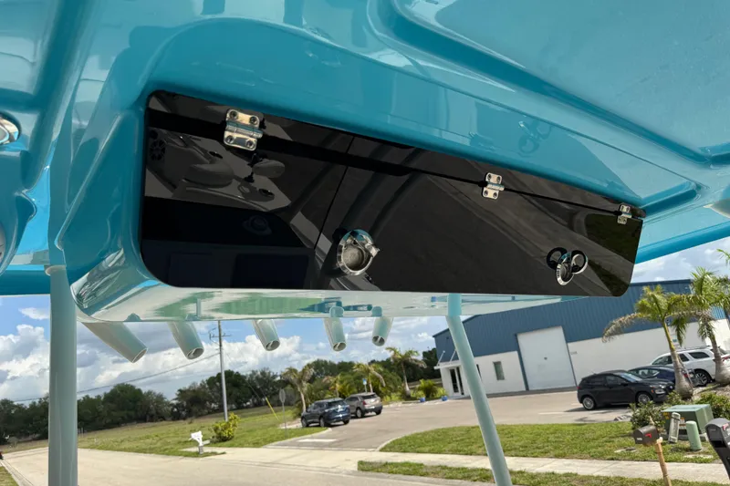 Slide: The Image of 2024 Key West 263 FS boat with blue T-top and storage compartment. - 34