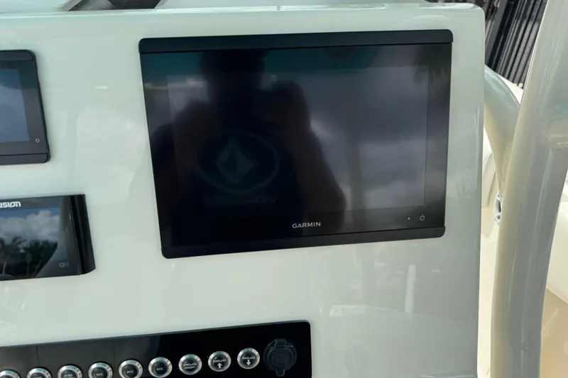 Slide: The Image of 2024 Key West 263 FS boat dashboard with Garmin display and control panel. - 36