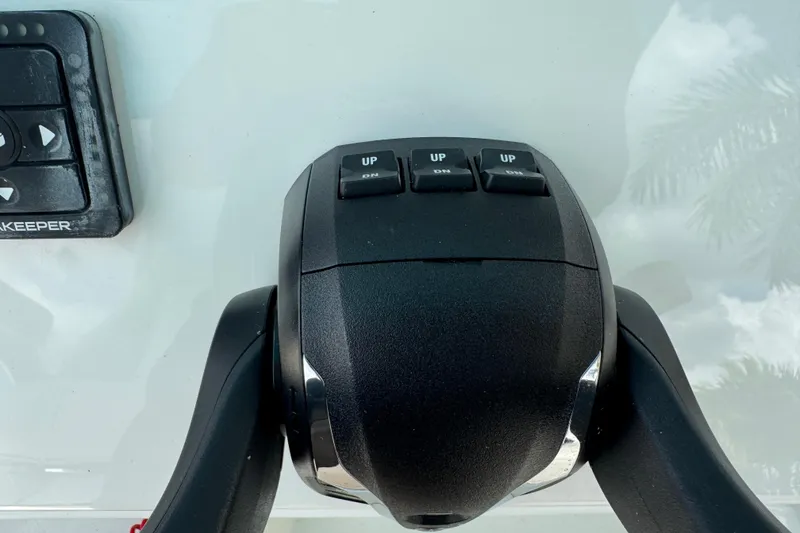 Slide: The Image of Throttle control panel on 2024 Key West 263 FS boat, featuring "UP" buttons. - 43
