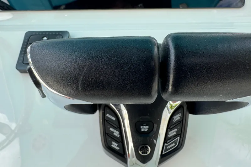 Slide: The Image of Throttle controls on a 2024 Key West 263 FS boat dashboard. - 44
