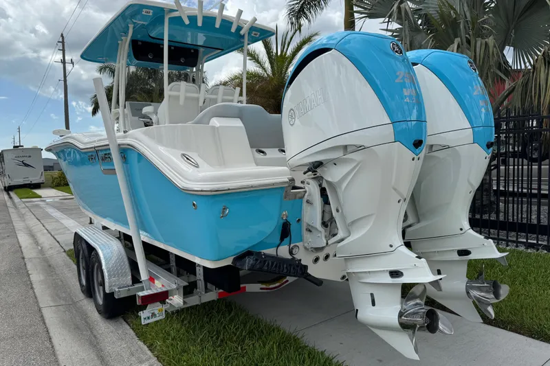 Slide: The Image of 2024 Key West 263 FS boat with twin Yamaha engines on a trailer. - 5