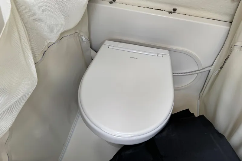 Slide: The Image of 2024 Key West 263 FS boat interior with compact marine toilet. - 52