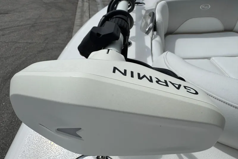 Slide: The Image of 2024 Key West 263 FS boat with Garmin equipment, featuring sleek white seating. - 54