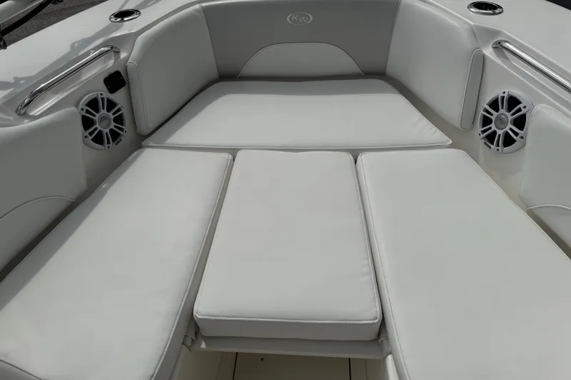 Slide: The Image of 2024 Key West 263 FS boat interior with cushioned seating and built-in speakers. - 55